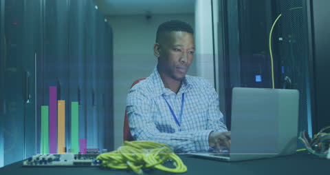 IT Professional Analyzing Data in Server Room Environment