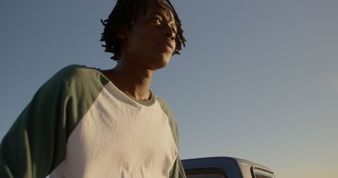 Contemplative Young Man Relaxing by the Oceanside
