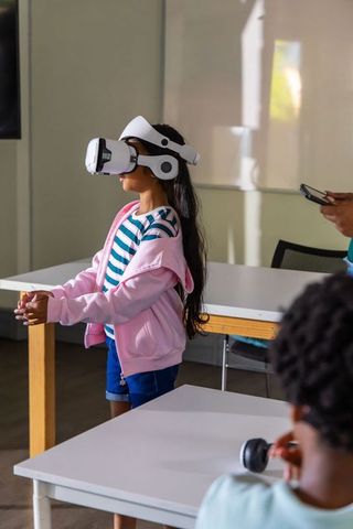 Girl wearing virtual reality headset exploring immersive stem learning in classroom