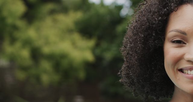 Smiling Woman with Curly Hair in Outdoor Setting - Download Free Stock Images Pikwizard.com