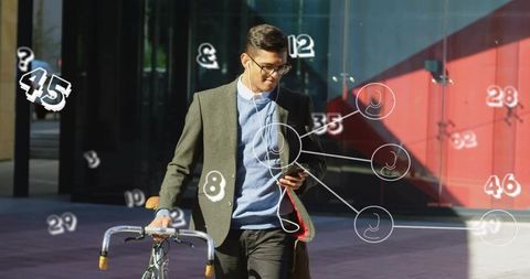 Young professional walking bicycle checking phone with ar overlays in urban plaza