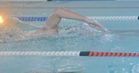 Athlete Swim Training in Indoor Pool with Lanes