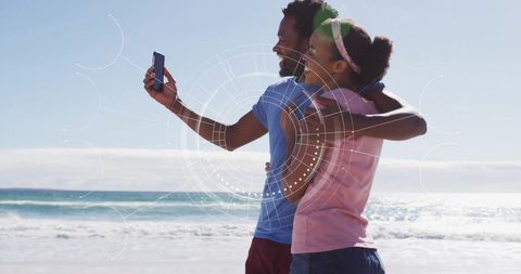 Couple Capturing Beach Memories with Smartphone and Augmented Reality