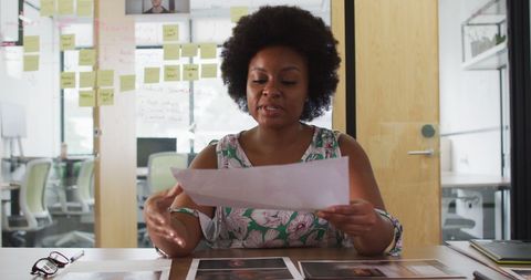 Businesswoman presenting designs in creative office
