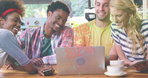 Young friends gathering in café with laptop for online collaboration