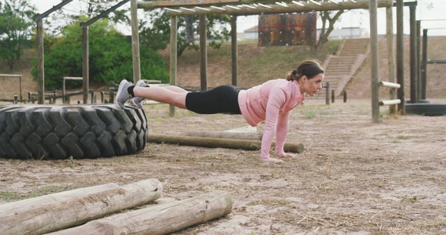 Woman Exercising with Push-ups in Outdoor Obstacle Course - Download Free Stock Images Pikwizard.com