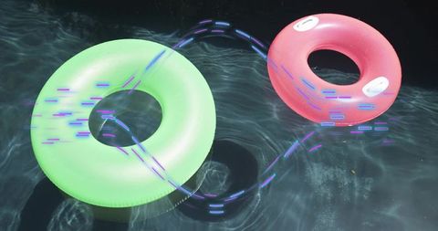 Floating neon pool rings casting purple light trails over dark water with caustics