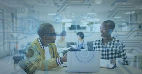 Innovative Colleagues Discussing Ideas in Tech-Savvy Office