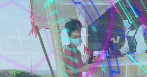 Outdoor food vendor processing payment by sea in tropical setting