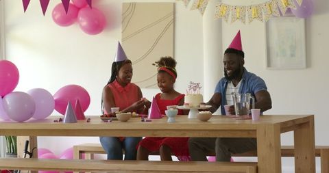 Joyful African American Family Celebrating Birthday with Cake and Decorations