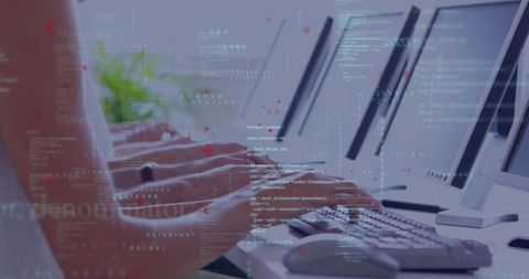 Programmers typing code on office keyboards in modern workspace