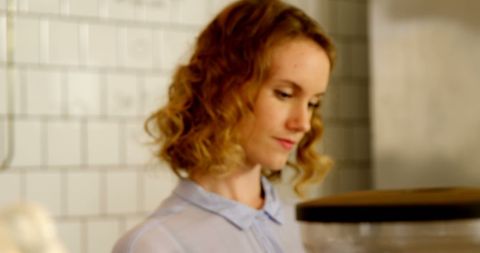 Barista crafting espresso beverage at coffee shop counter