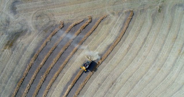 Aerial View of Harvesting Machine in Field with Curved Crop Rows - Download Free Stock Photos Pikwizard.com