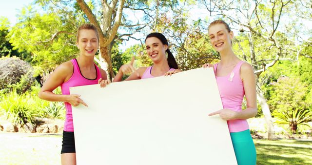 Three Women in Pink Holding Blank Sign Board Outdoors for Awareness Campaign - Download Free Stock Images Pikwizard.com