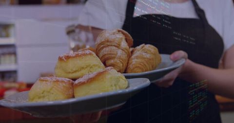 Server Presenting Fresh Pastries at Bakery Counter