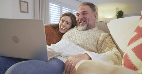 Senior Couple Enjoying Quality Time at Home on Laptop