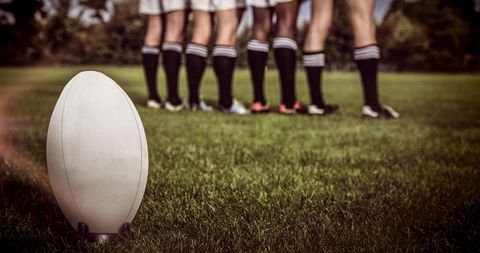 Rugby Players and Ball on Field, Team Awaiting Action