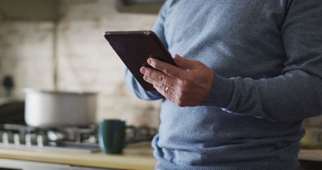 Man Using Tablet in Kitchen While Cooking - Download Free Stock Images Pikwizard.com