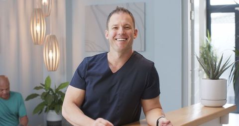 Smiling Medical Professional in Clinic Reception Area by Modern Lights