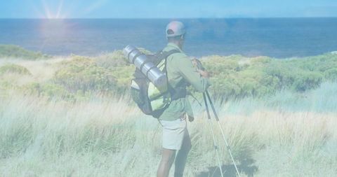Hiker with backpack exploring scenic coastal landscape