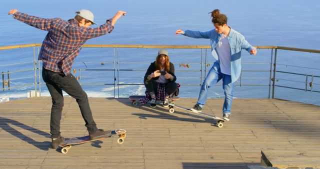 Young Friends Skateboarding and Filming Tricks Near Ocean - Download Free Stock Images Pikwizard.com