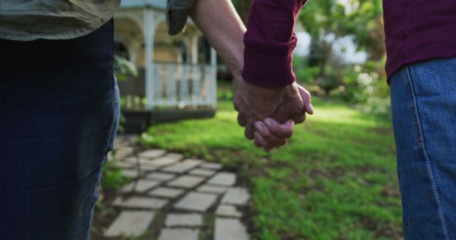 Rear view midsection of senior caucasian couple relaxing, walking in garden holding hands - Download Free Stock Photos Pikwizard.com