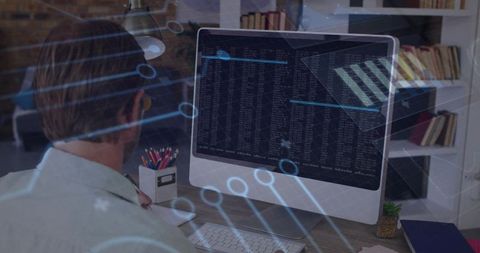 Programmer Coding on Desktop with Futuristic Data Overlay