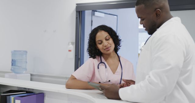 Doctors Discussing Patient Record in Hospital Reception Area - Download Free Stock Images Pikwizard.com