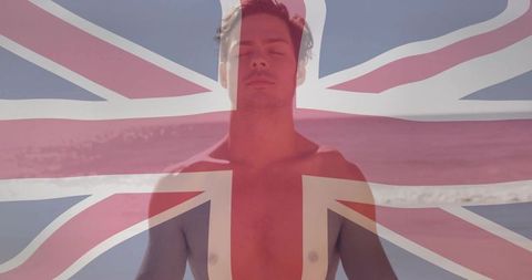 Meditative shirtless man at serene beach with uk flag overlay