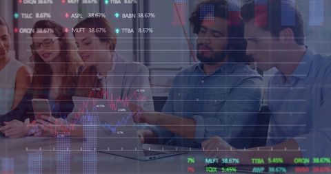 Colleagues analyzing financial data with technology in office