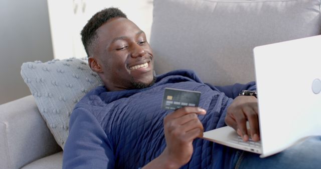 Smiling Man Shopping Online While Holding Credit Card - Download Free Stock Images Pikwizard.com