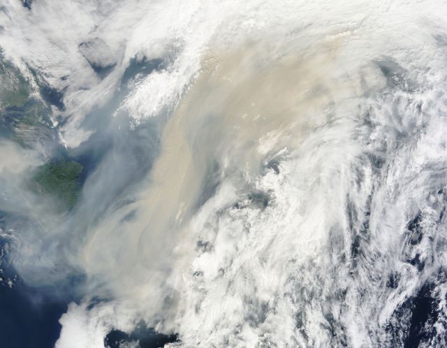 High-resolution image shows large smoke plume from Canadian wildfires traveling over Atlantic Ocean. Useful for studying impact of wildfires on air quality and climate, and satellite technology in environmental monitoring.