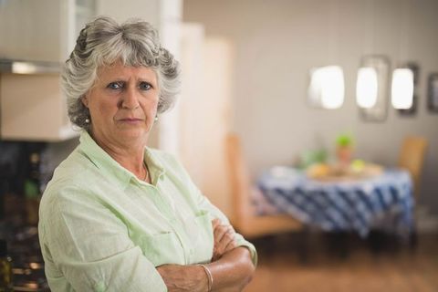 Senior Woman with Arms Crossed in Home Kitchen Showing Confidence