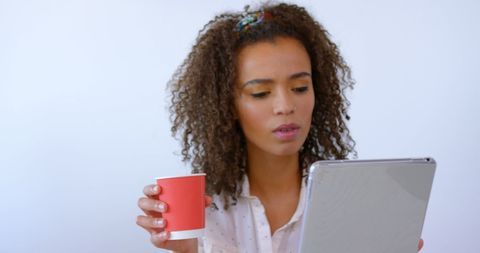 Young Woman with Tablet and Red Cup