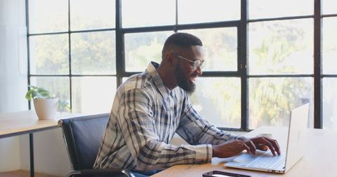 Businessman Engaged in Virtual Meeting in Modern Office