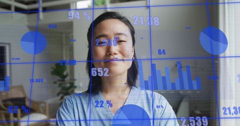 Korean professional presenting blue data visualization overlay in home office