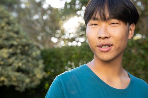 Casual Young Man in Garden with Braces Enjoying Nature