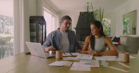 Engaged couple planning wedding at home