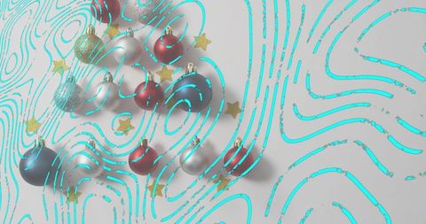 Arranging turquoise topographic swirls around red silver gold baubles and glitter stars