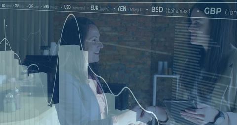 Global Businesswomen Analyzing Financial Data on Tablet