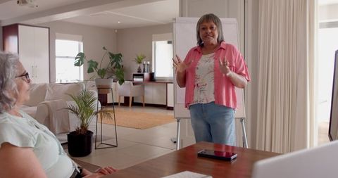 Mature Woman Leading Business Presentation in Home Office