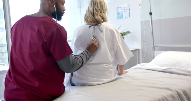 The content shows a nurse in a modern hospital room, attentively checking a patient's vitals with a stethoscope. This might be useful for illustrating healthcare settings, medical procedures, nurse responsibilities, patient care, hospital environments, or healthcare-related articles and advertisements.