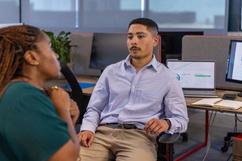 Coworkers Discussing Business Strategy in Modern Office