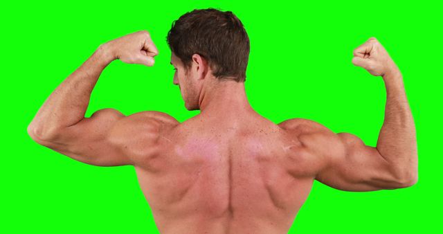 Rear view of caucasian strong man flexing muscles with copy space on green screen. Strength and fitness concept.