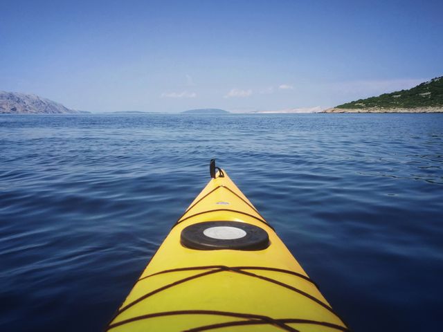 Yellow Kayak on Calm Blue Sea with Distant Islands Under Clear Sky - Download Free Stock Photos Pikwizard.com