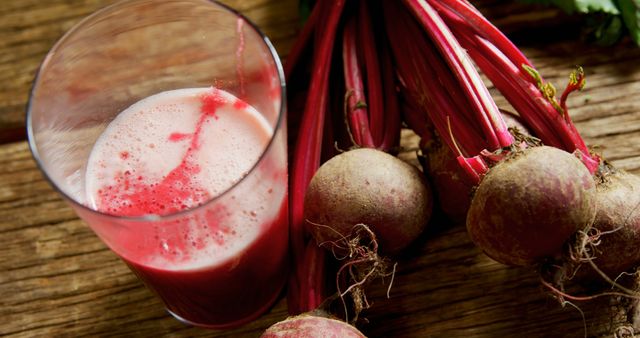 Fresh Beetroot Juice in Glass with Whole Beetroots on Wooden Table - Download Free Stock Images Pikwizard.com