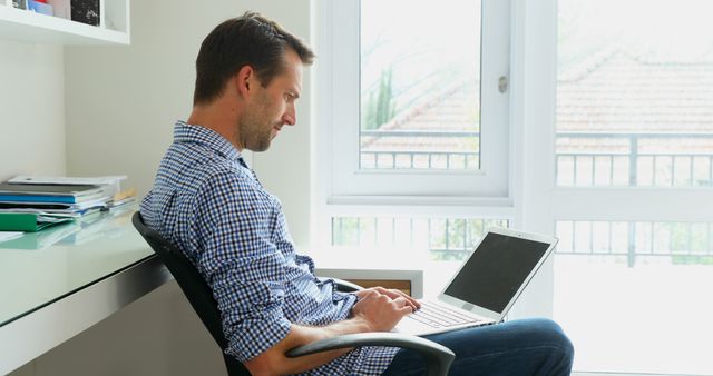 Man Working From Home on Laptop in Bright Office - Download Free Stock Images Pikwizard.com