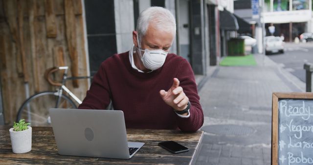 Senior Man Wearing Face Mask Using Laptop at Outdoor Cafe - Download Free Stock Images Pikwizard.com