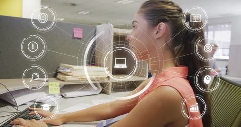 Korean woman typing at modern office desk with digital hud overlay for productivity