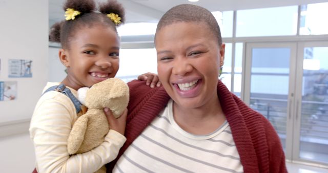 Mother and Daughter Smiling with Teddy Bear in Hospital - Download Free Stock Images Pikwizard.com